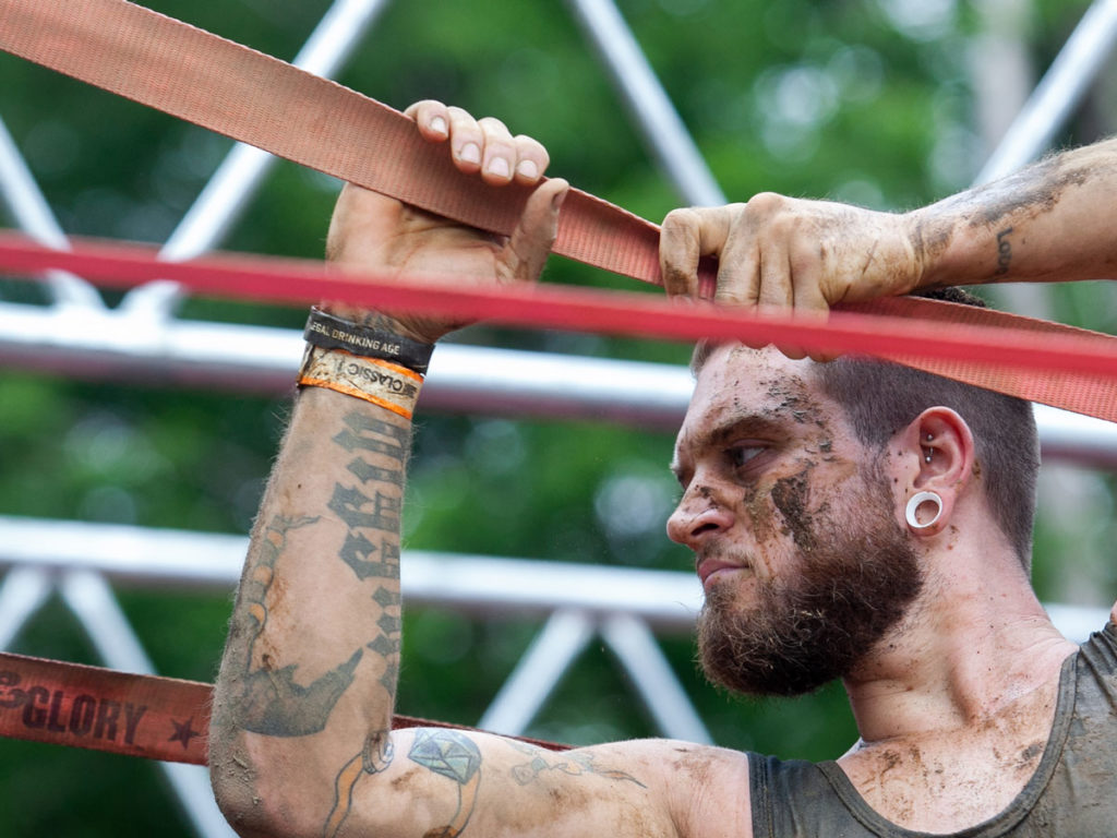 Participant holding tightly in a rope with serious face