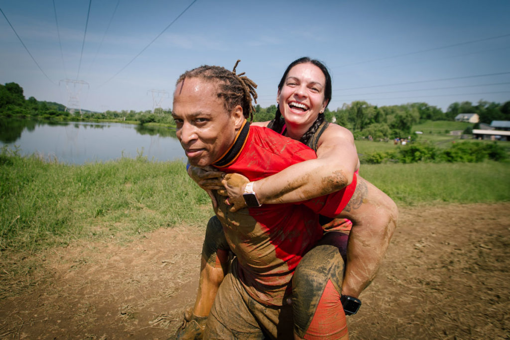 Participant in the back of her teammate is smiling widely