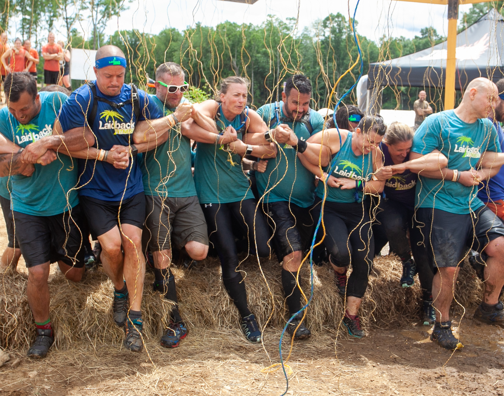 Participants linking arms while passing through Electroshock Therapy