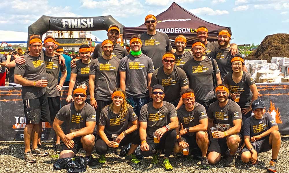 Participants taking a group shot at the finish line