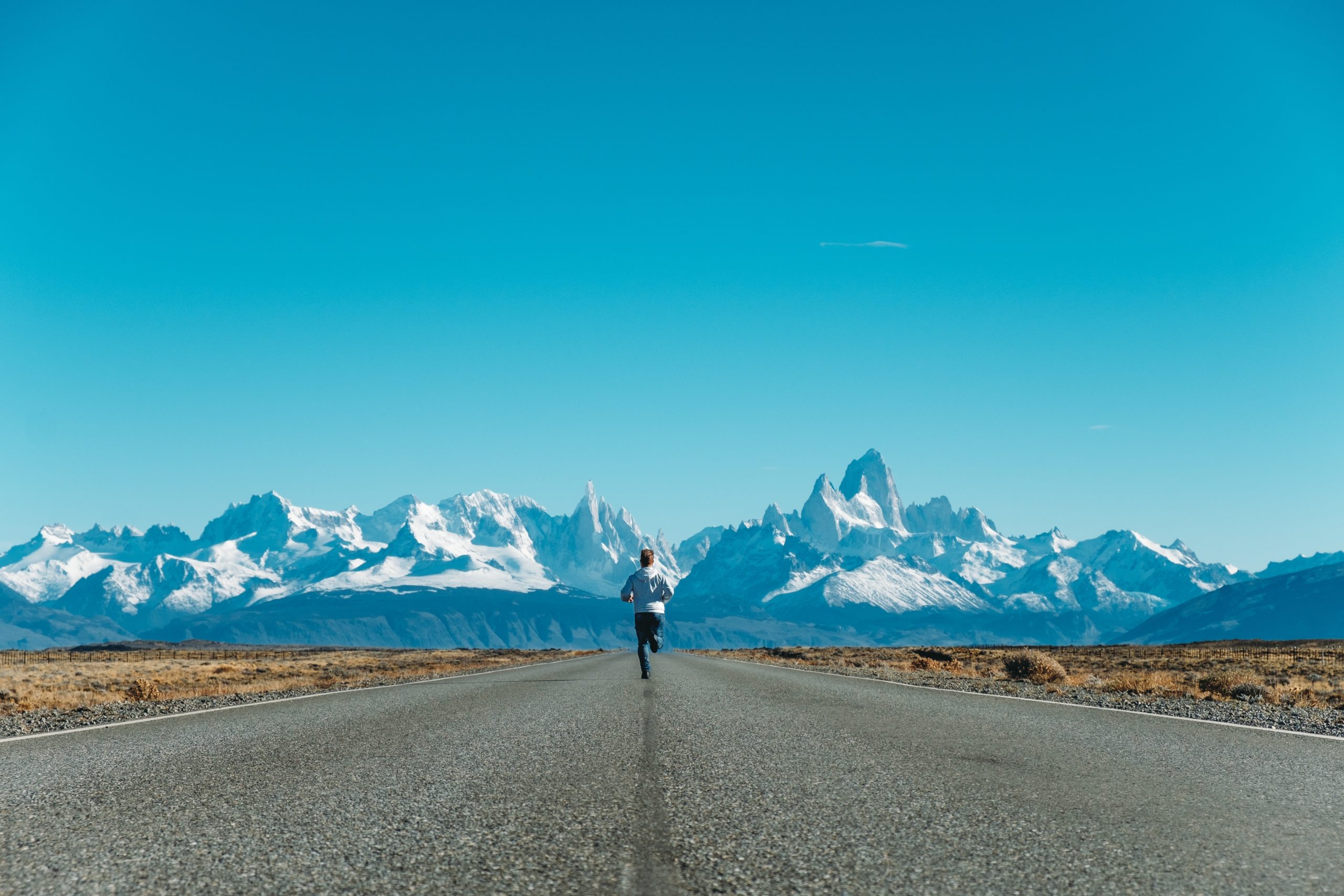 Man running towards an icy mountain