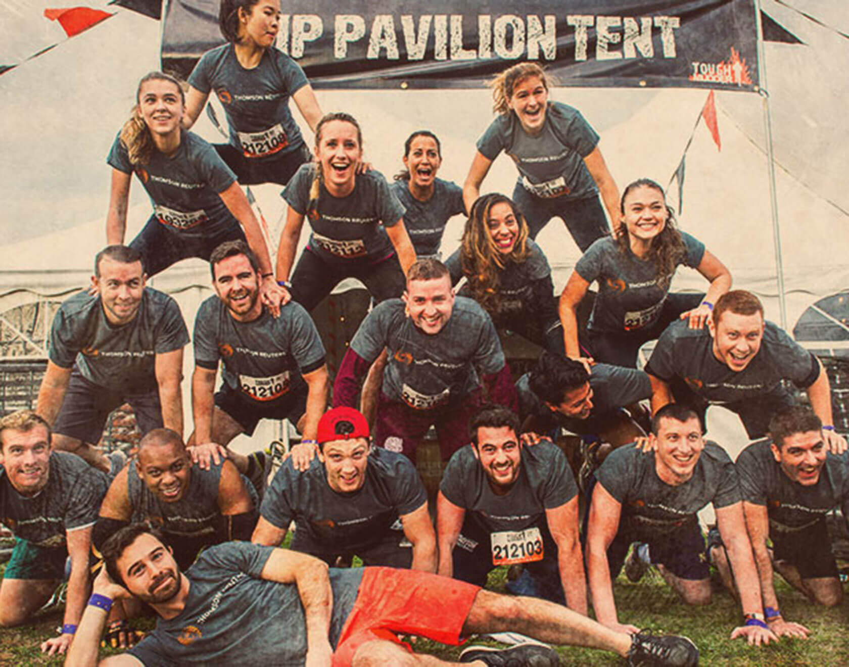 A group of participants doing pyramid for a picture
