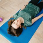 woman lies in restful yoga pose