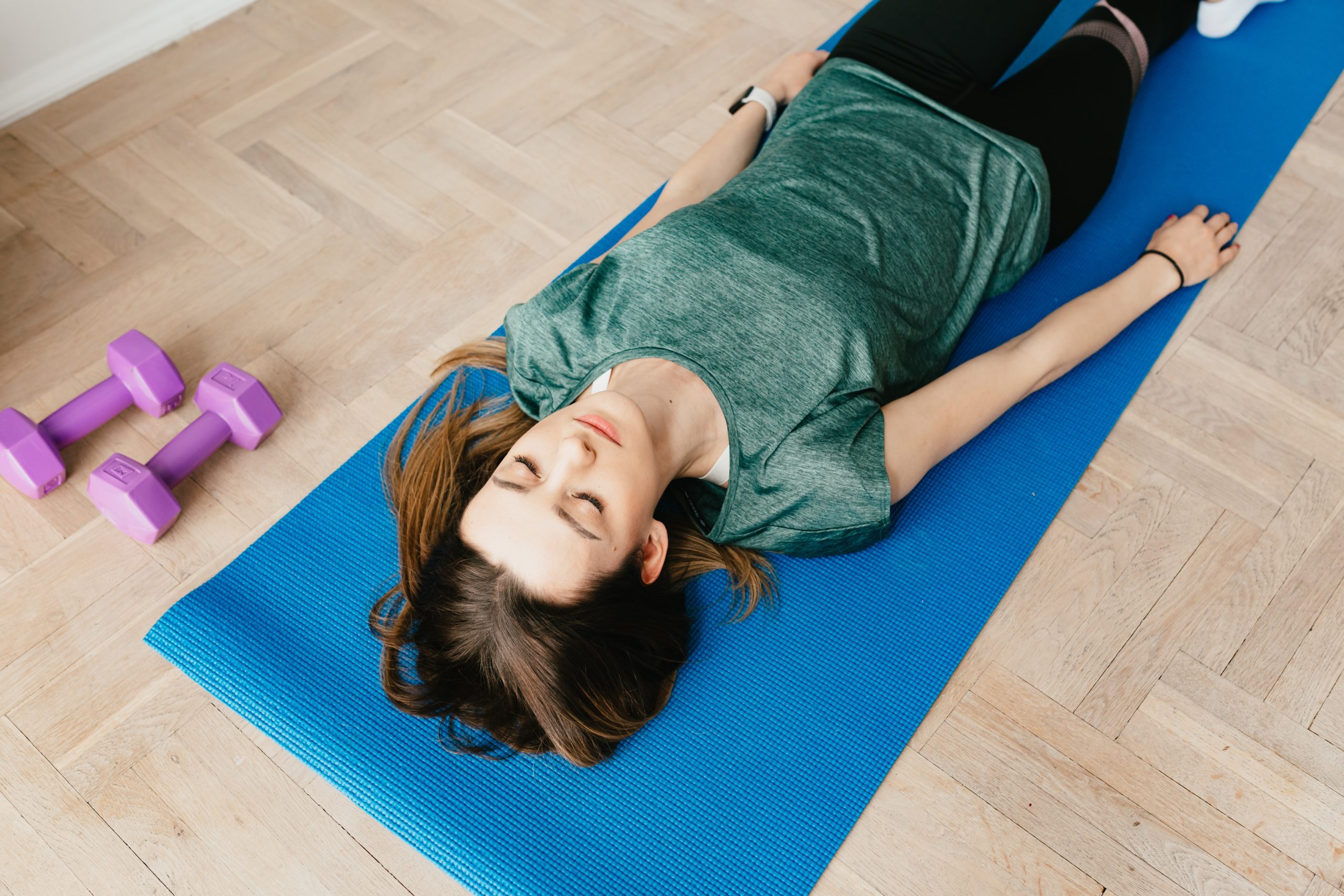 woman lies in restful yoga pose