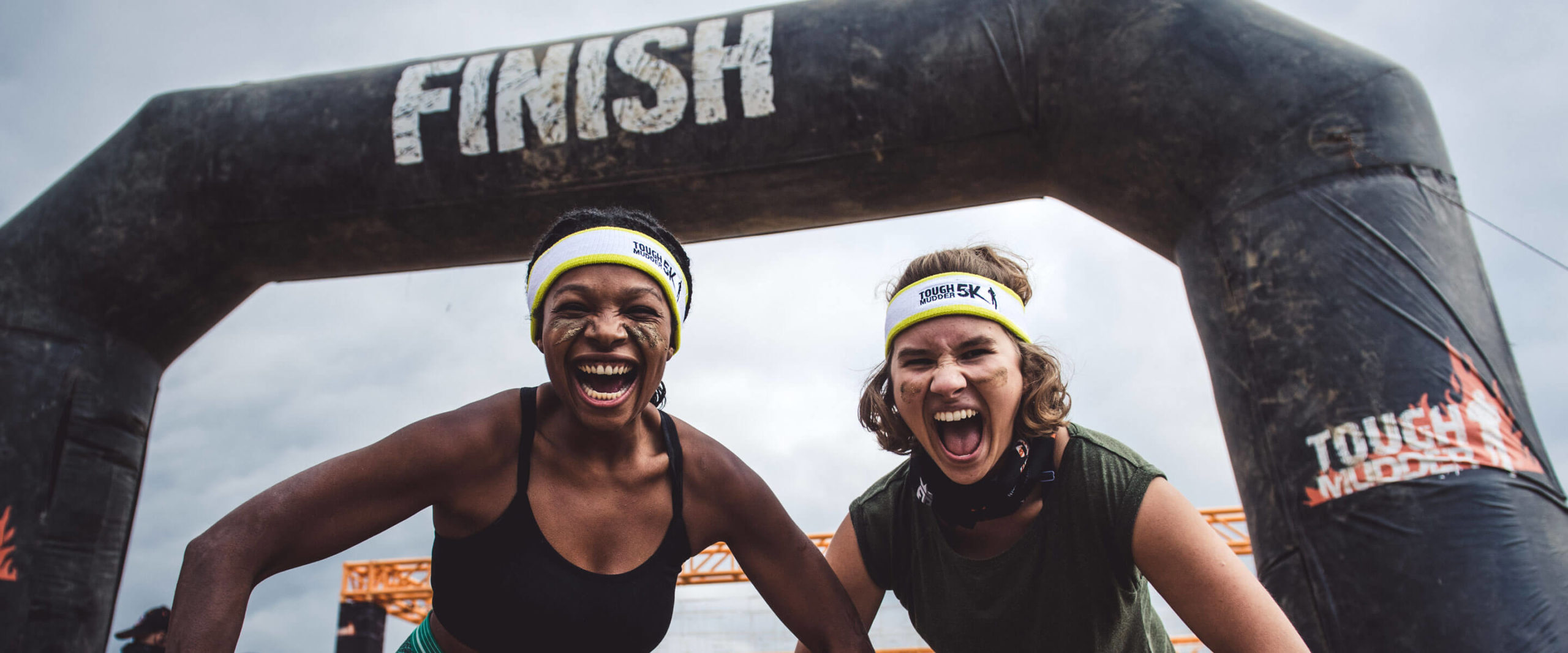Two participants screaming at the camera in the finish line
