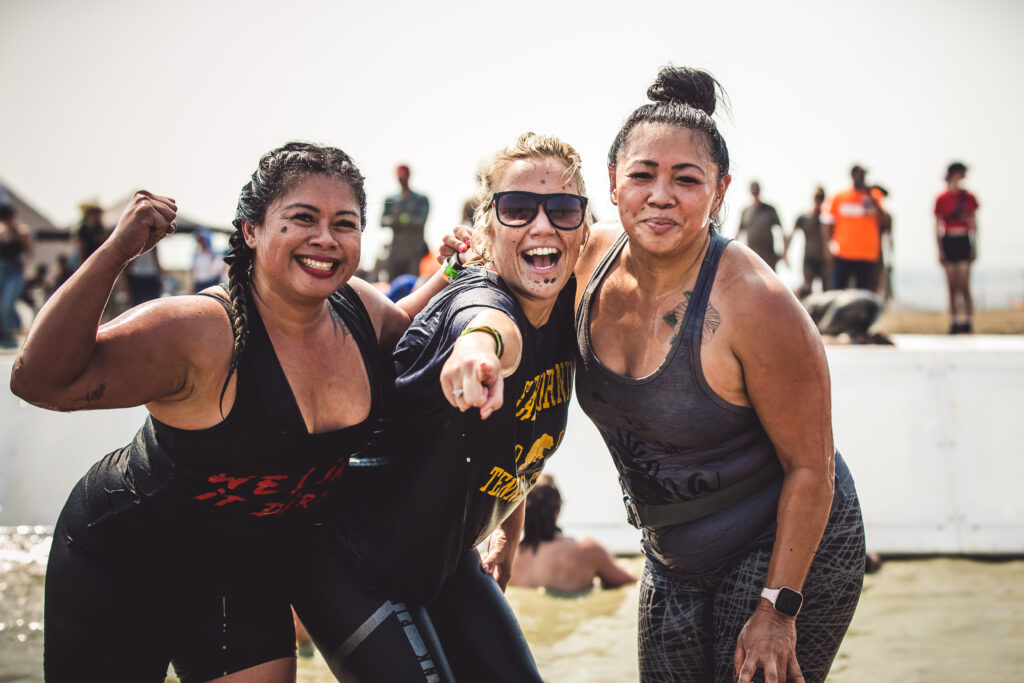 three girls at mud run obstacles